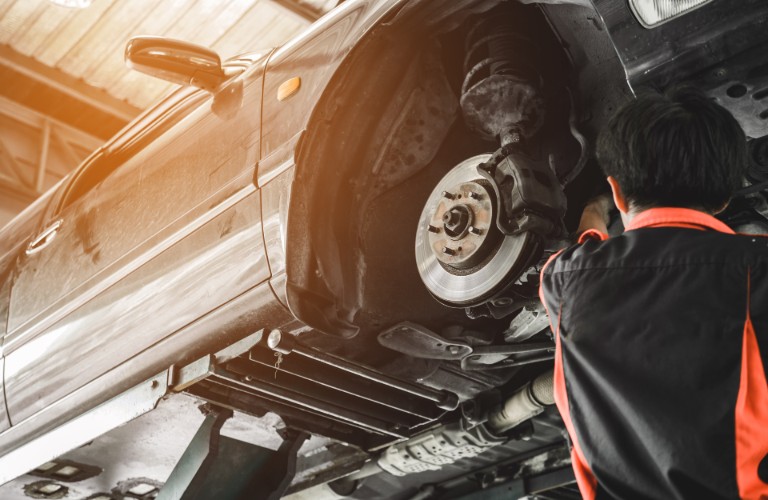 Mechanic changing the brakes on a car