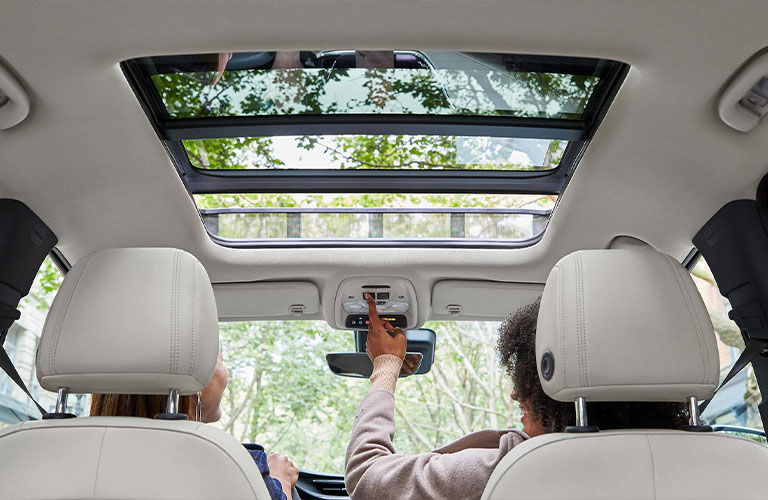 Two people sitting in the front seat of the 2021 Buick Encore