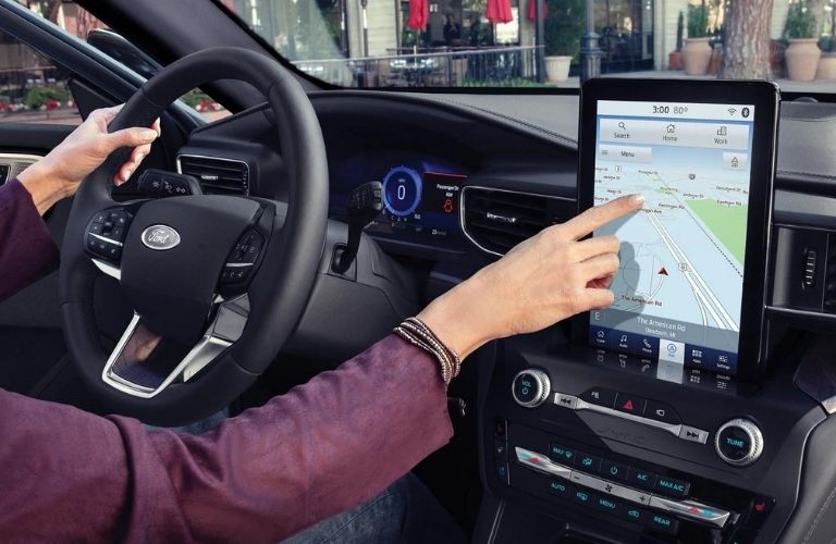 A person using the touchscreen in the 2021 Ford Explorer.