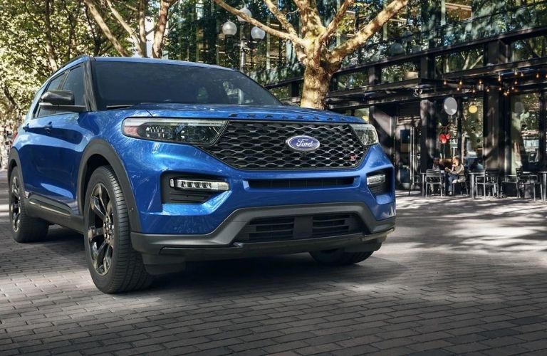 A blue 2021 Ford Explorer parked in the city.