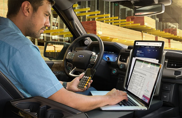 2022 Ford F-150 Lightning truck with a man inside