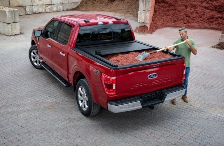 a man loading up the bed of the 2022 Ford F-150® Truck