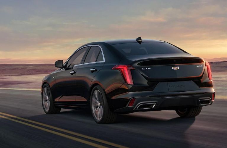 Rear view of the 2023 Cadillac CT4 driving on road