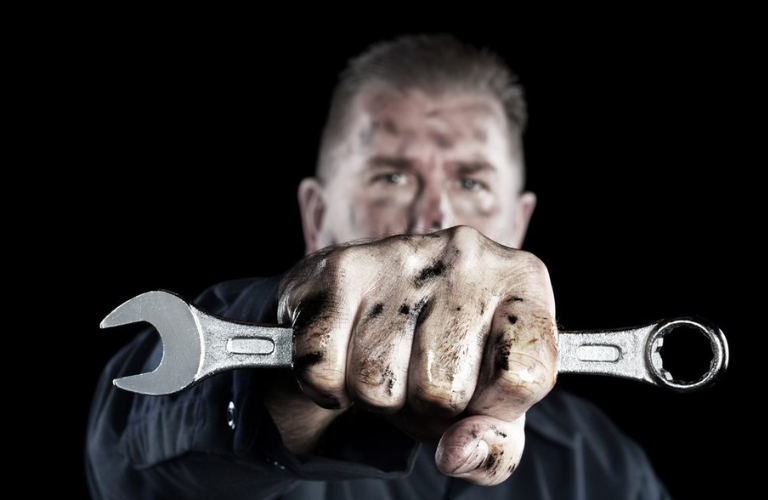 Mechanic posing with a tool