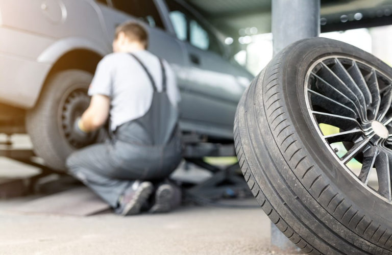 Close up of a tire while mechanic is inspecting a vehicle