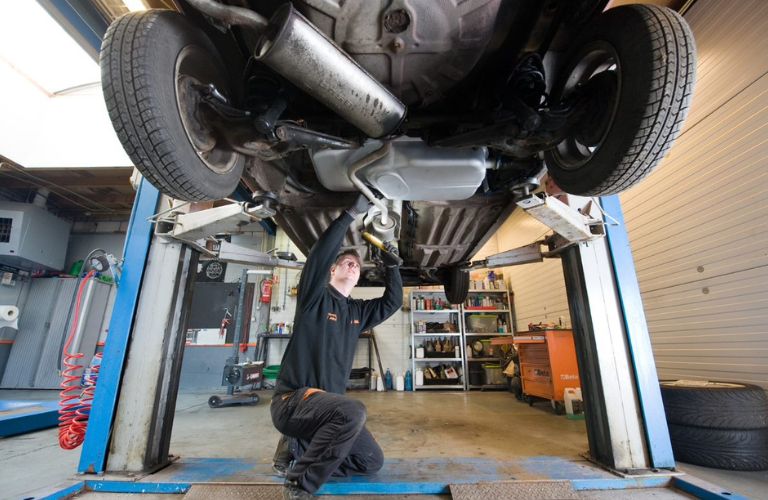 Mechanic inspecting the vehicle