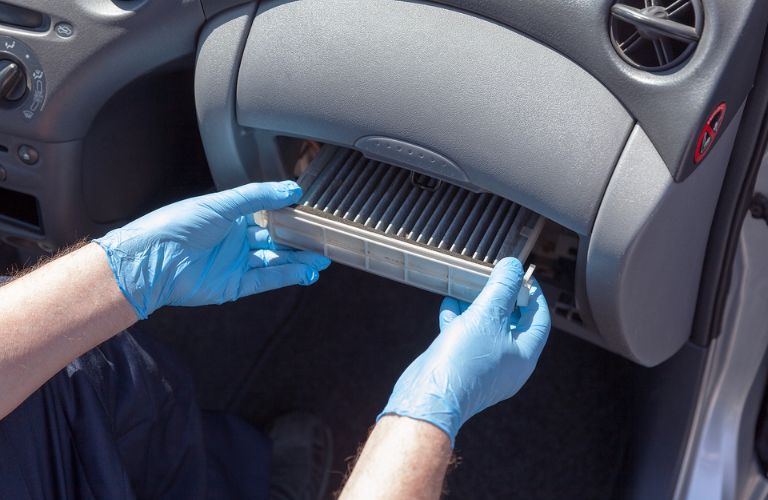 Service professional removing an old air filter