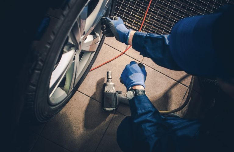Hands of a mechanic working on a vehicle