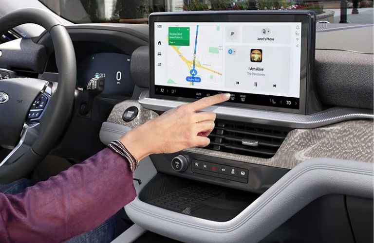 Hand of a lady using Ford touchscreen display