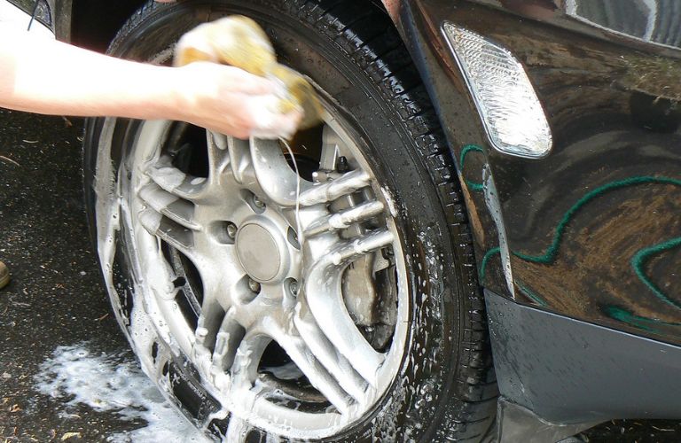 washing a tire of a car